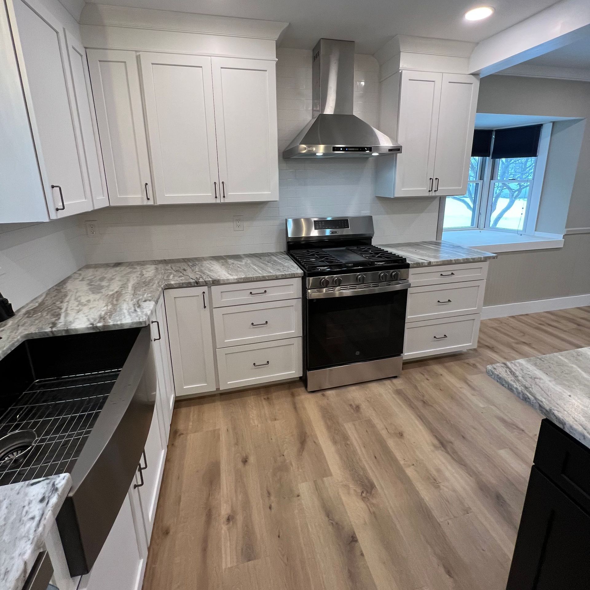 A kitchen with stainless steel appliances and white cabinets