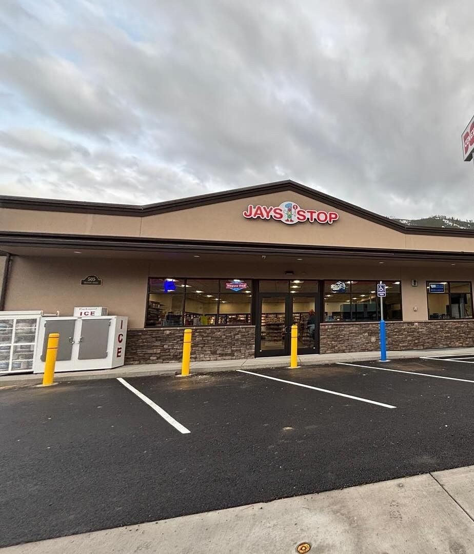 A convenience store with a sign that reads "JAVA STOP" on an overcast day.