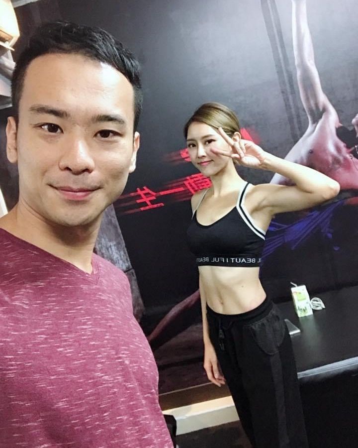 A man and a woman are posing for a picture in a gym.
