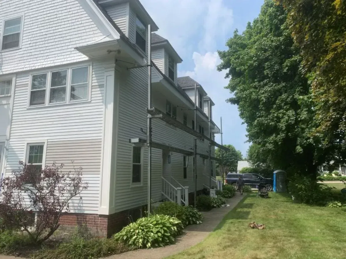 A white house with a lawn in front of it