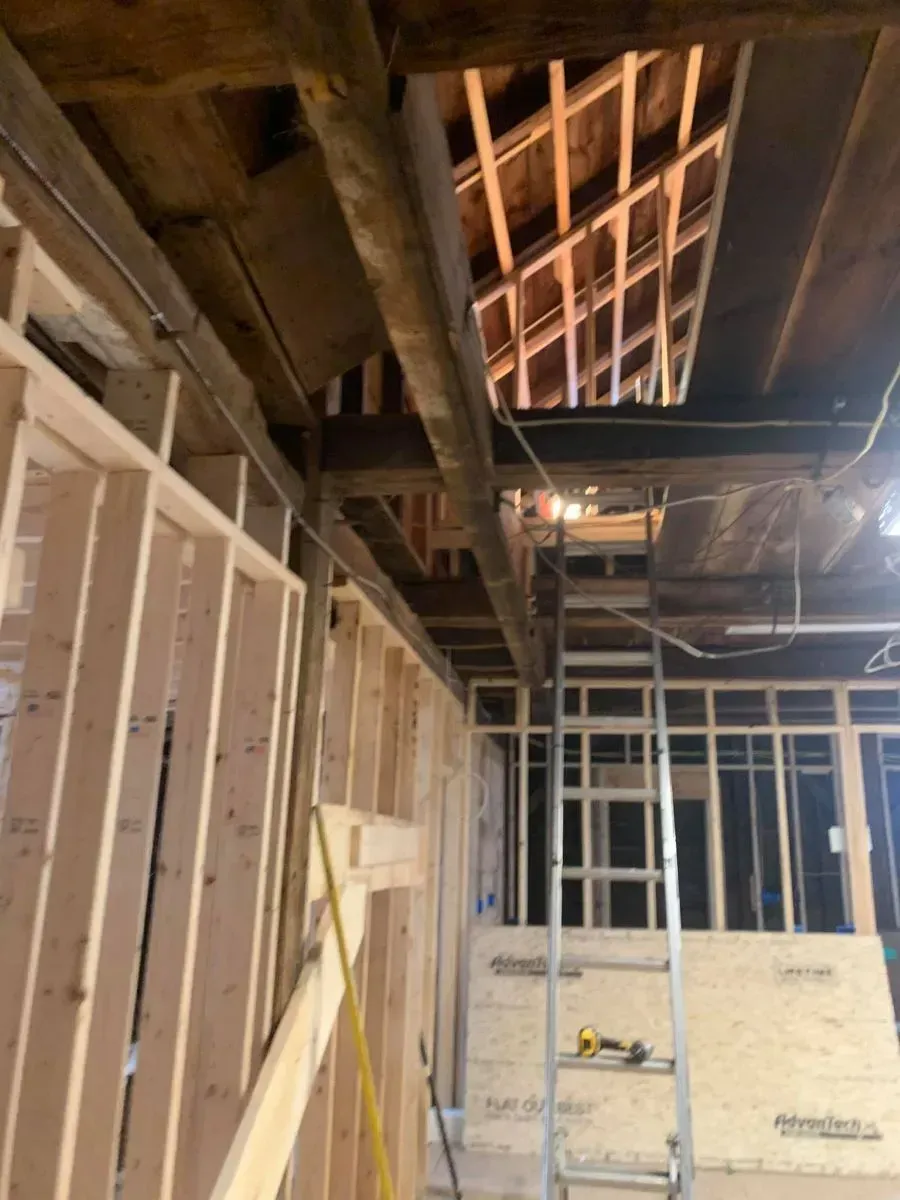 A ladder is hanging from the ceiling of a building under construction