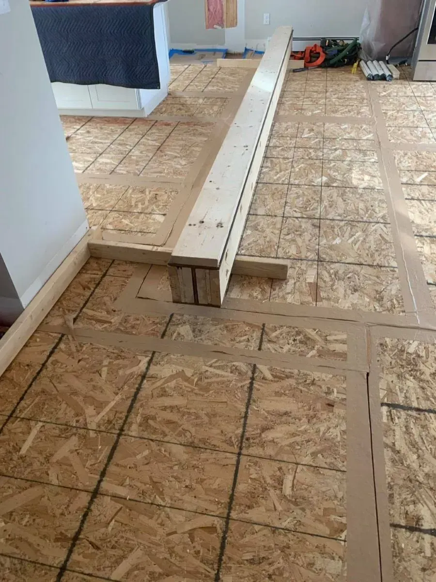 A wooden beam is sitting on top of a wooden floor.
