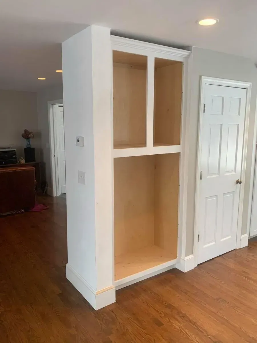 There is a bookshelf in the middle of the room.