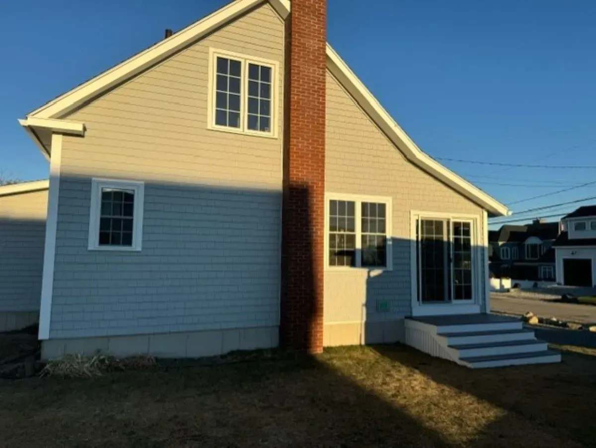 A house with a brick chimney on the side of it