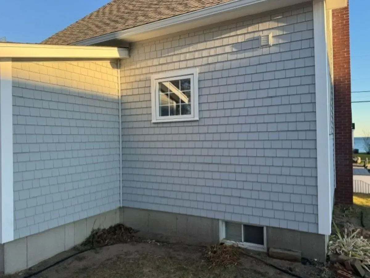 A white house with a window on the side of it