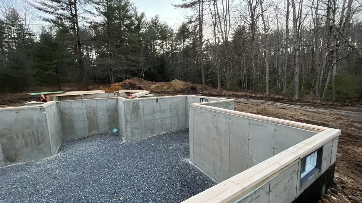 A concrete foundation is being built in the middle of a forest.
