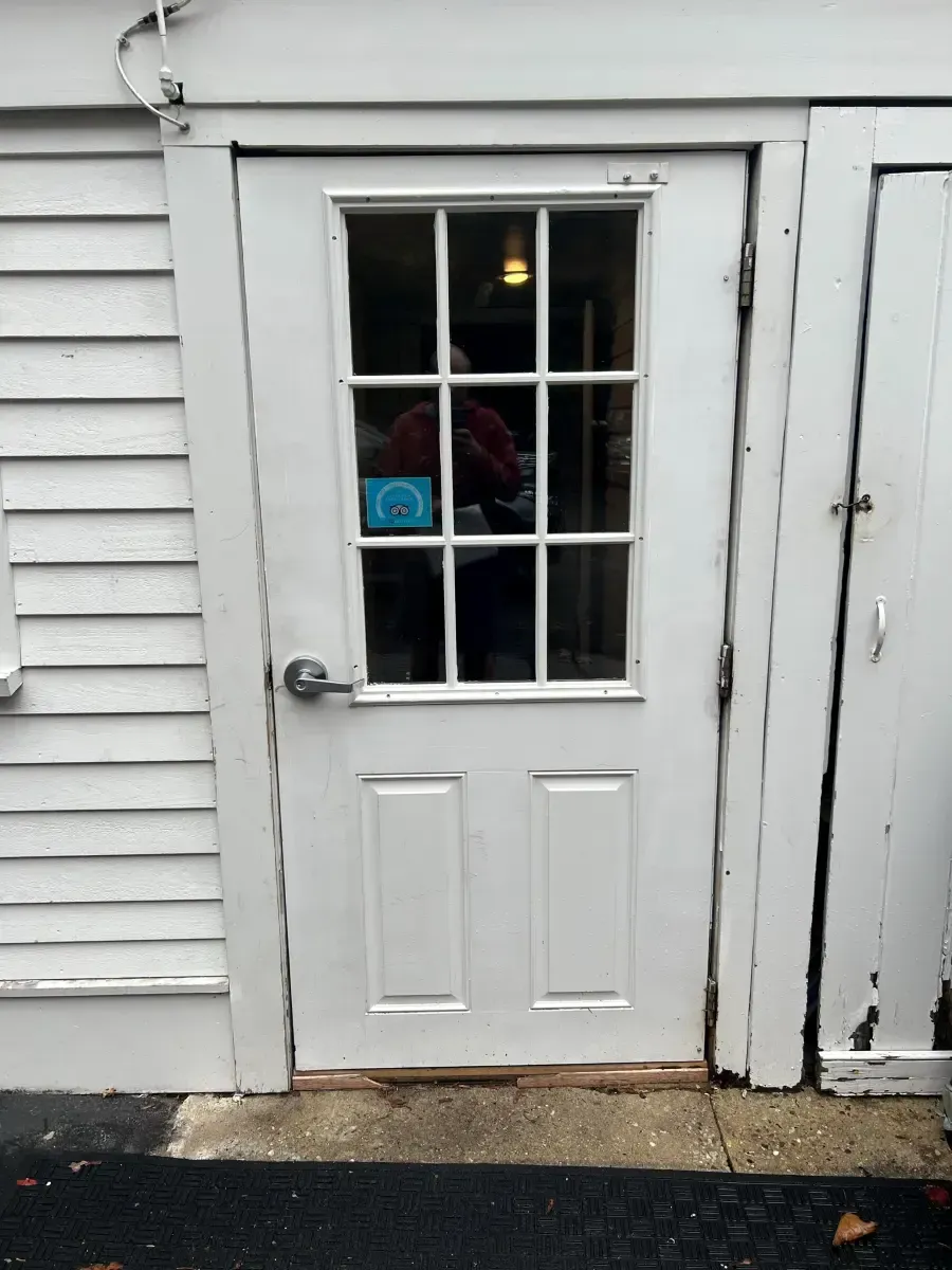 A white door with a sticker on it that says