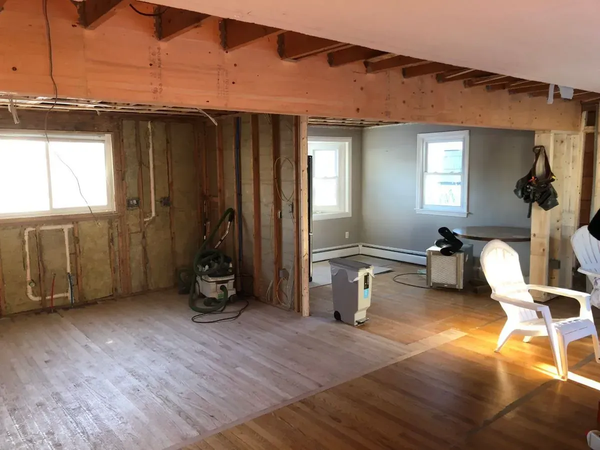 A room with wooden floors and a chair in it.