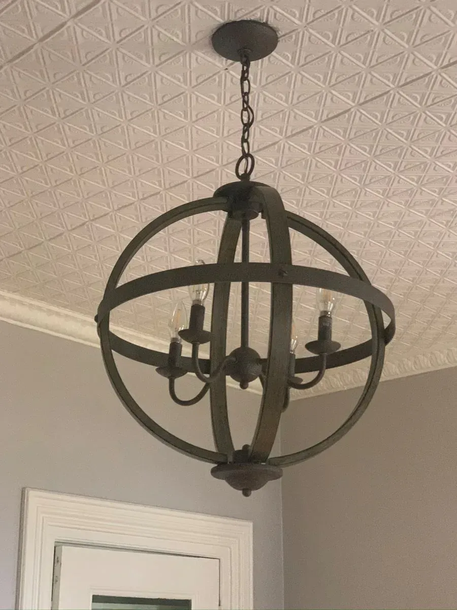 A chandelier is hanging from the ceiling in a room.