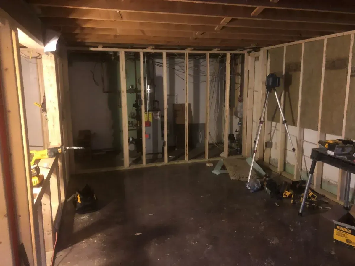 A room with wooden walls and a ladder in it.