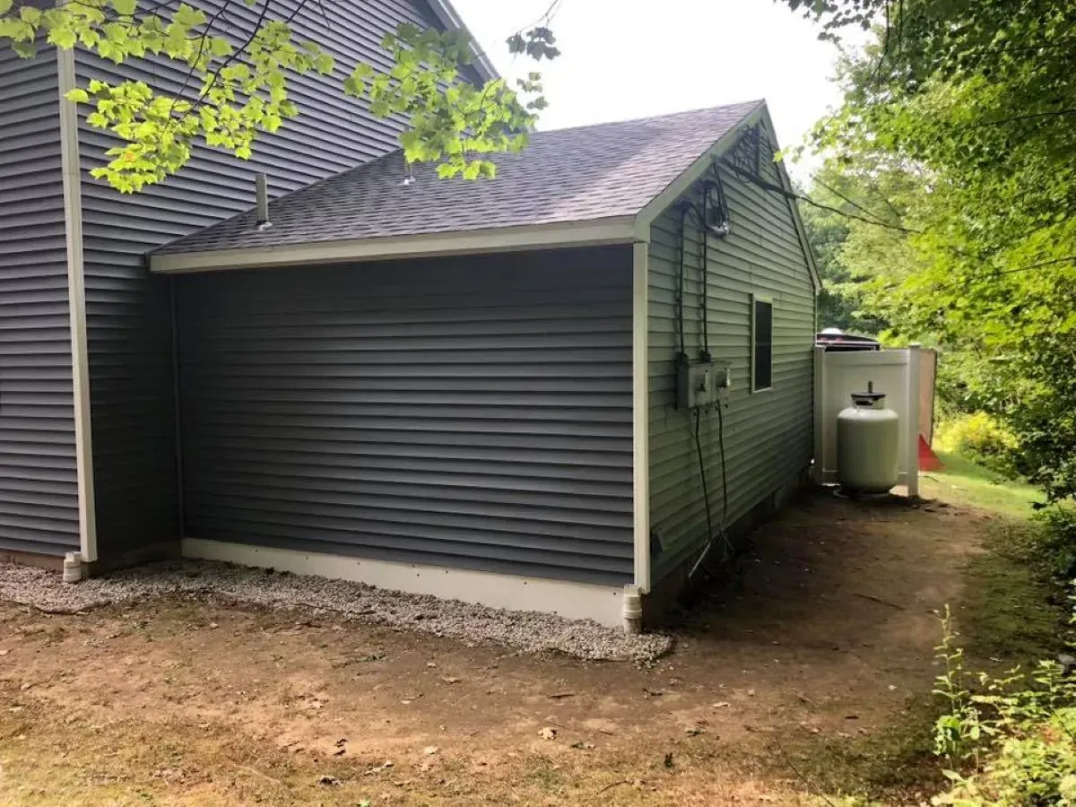 A garage is attached to the side of a house.