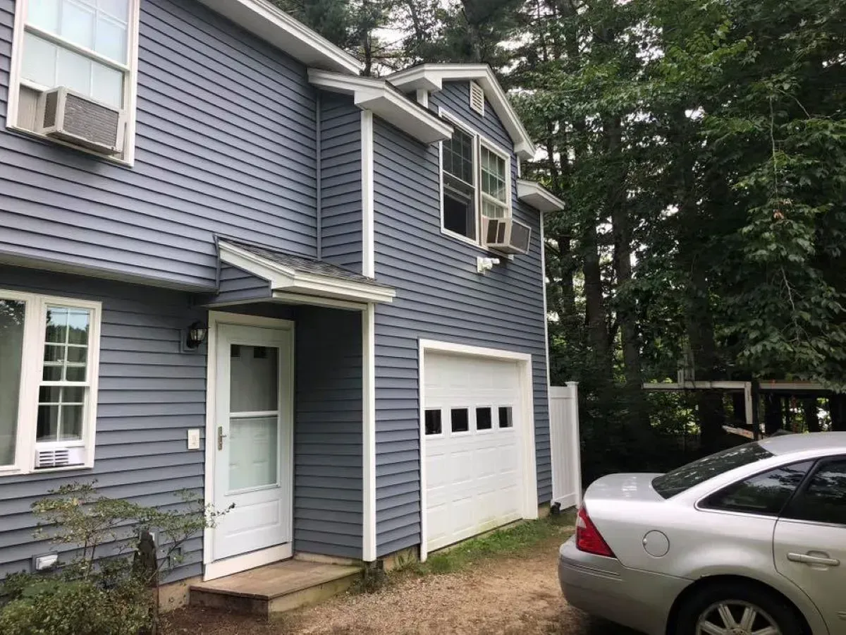 A house with a car parked in front of it