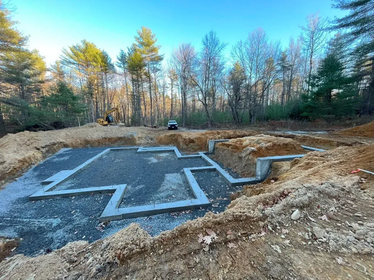 A foundation for a house is being built in the middle of a forest.