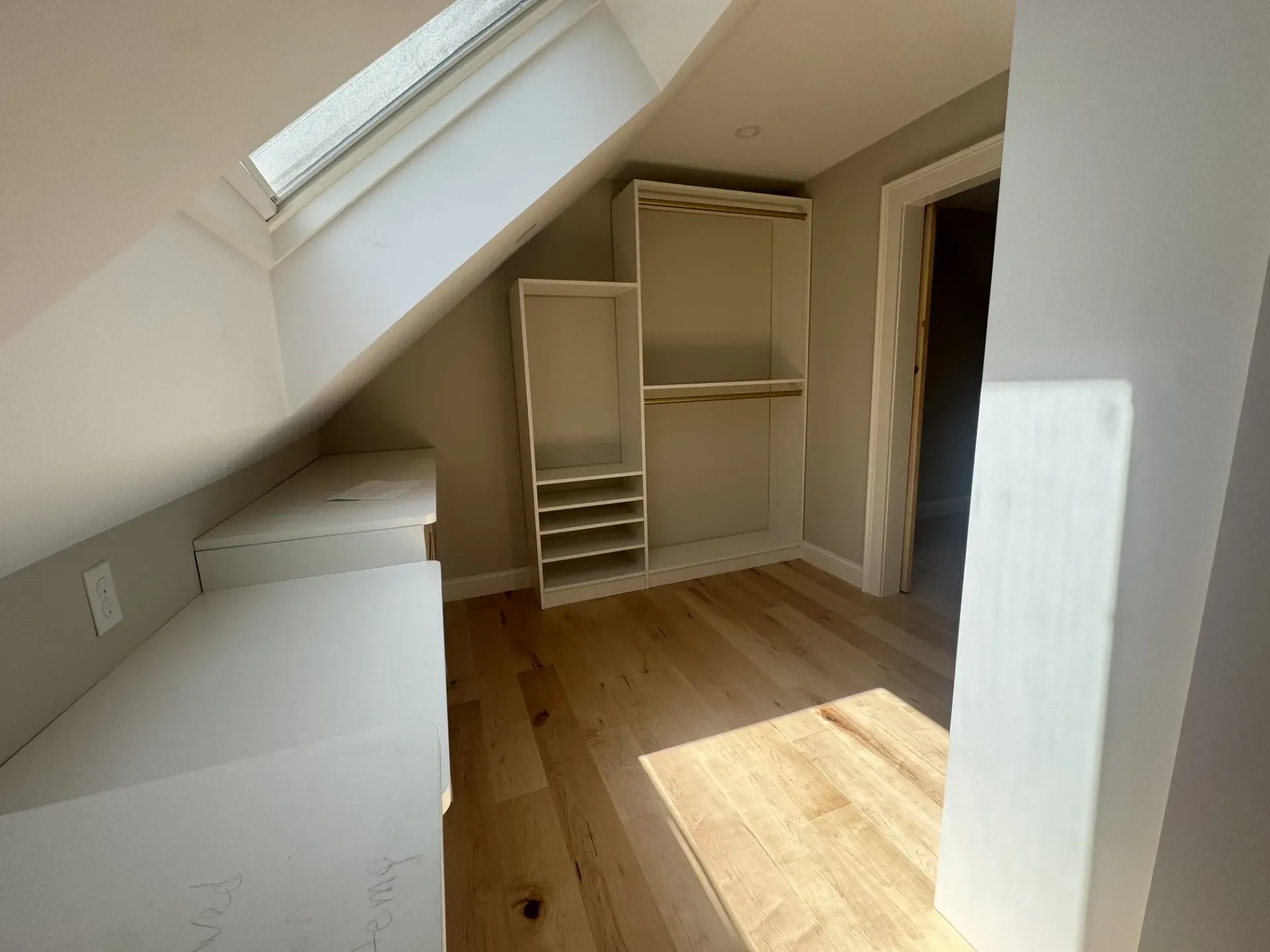 There is a skylight in the corner of the room.