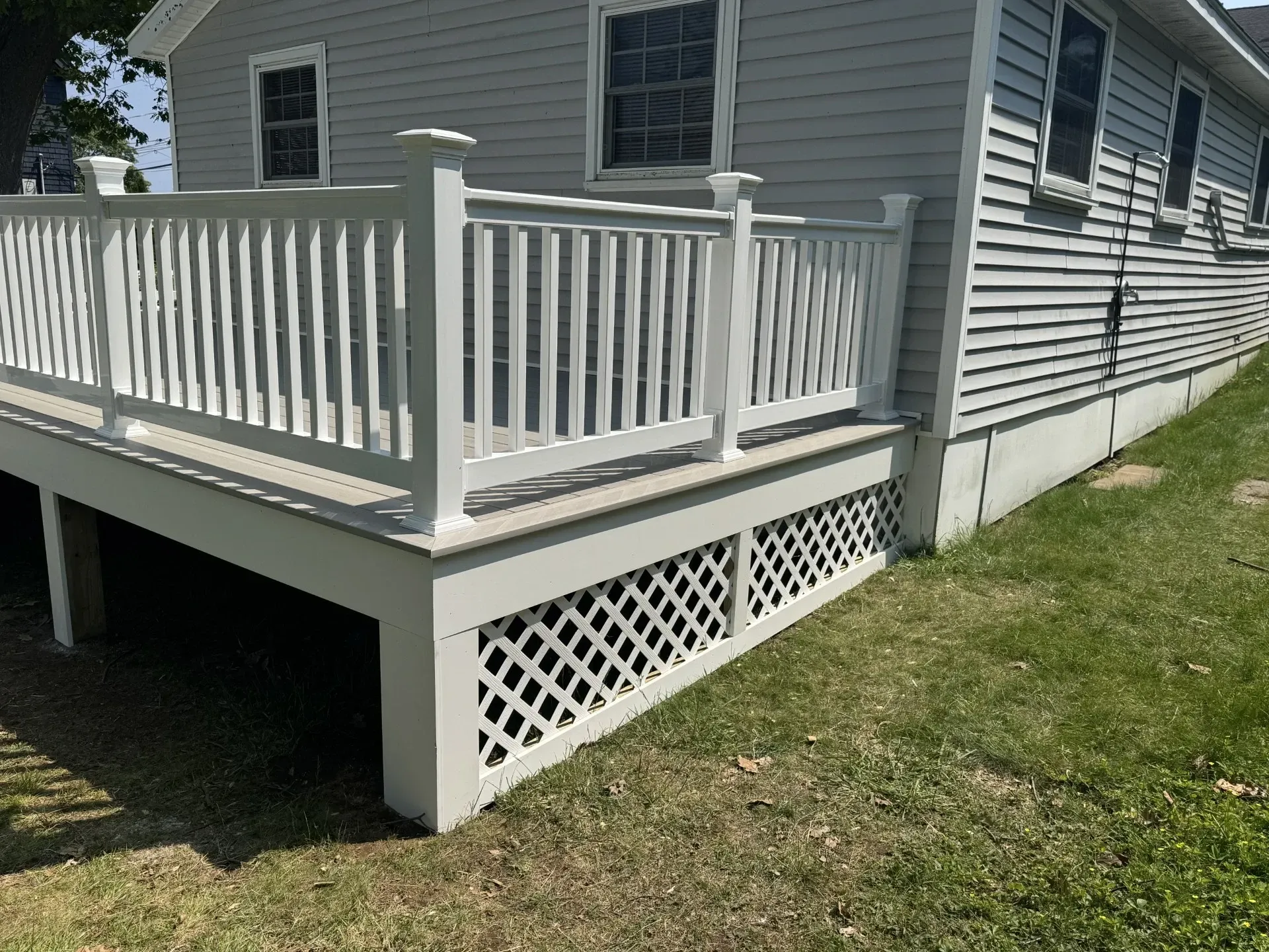 A house with a white deck and a white railing.