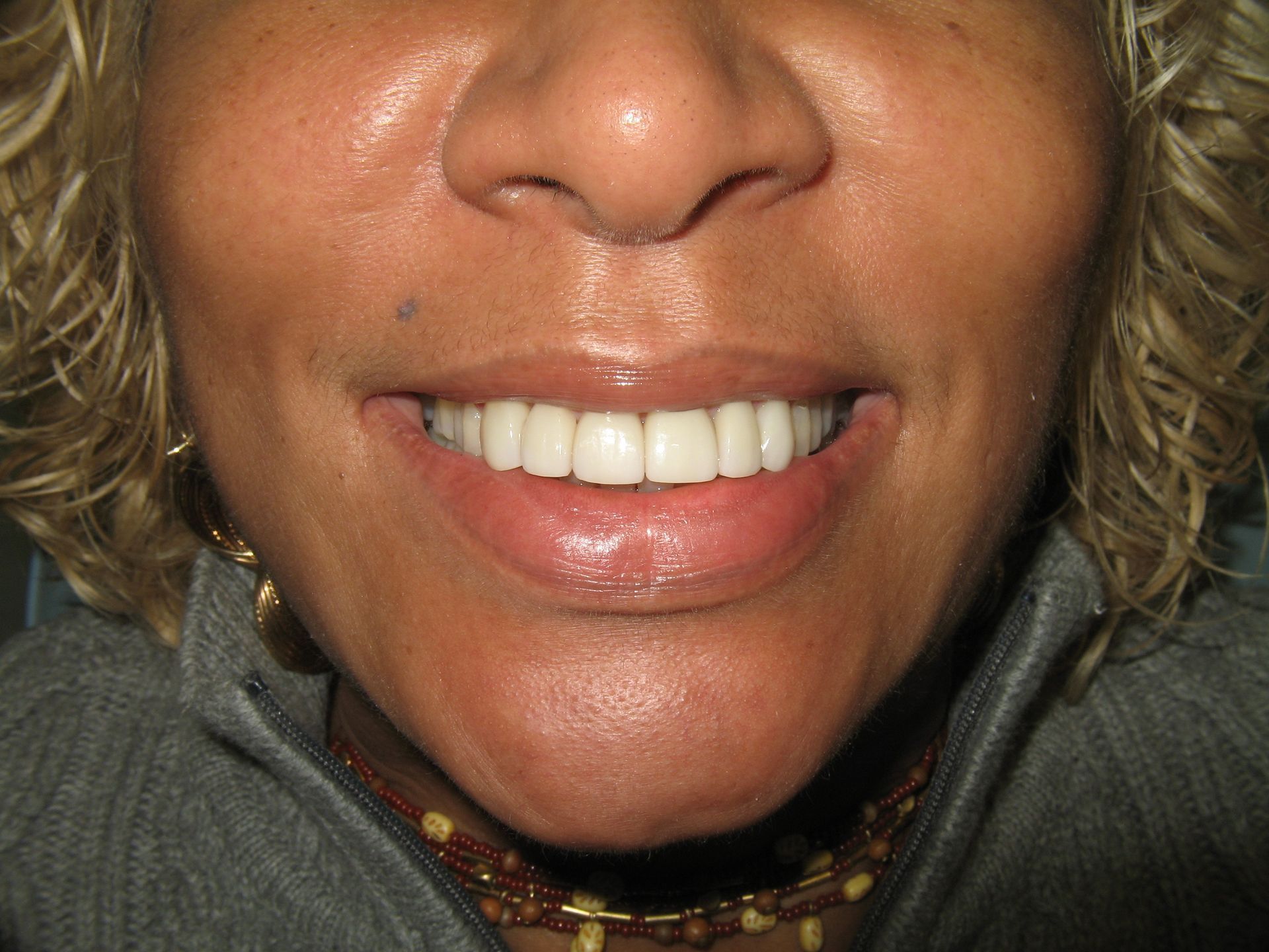 A close up of a woman 's face with a smile on her face.