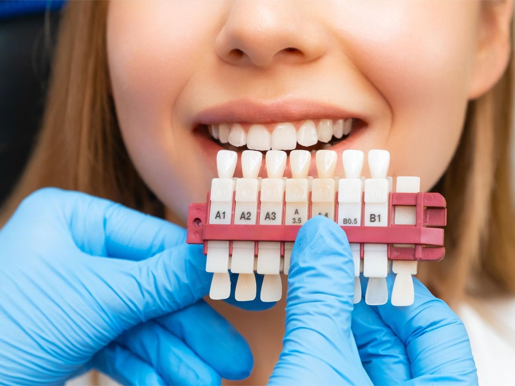 A woman is getting her teeth examined by a dentist.