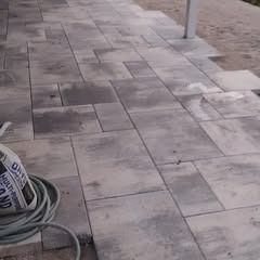 A hose is sitting on top of a brick walkway.