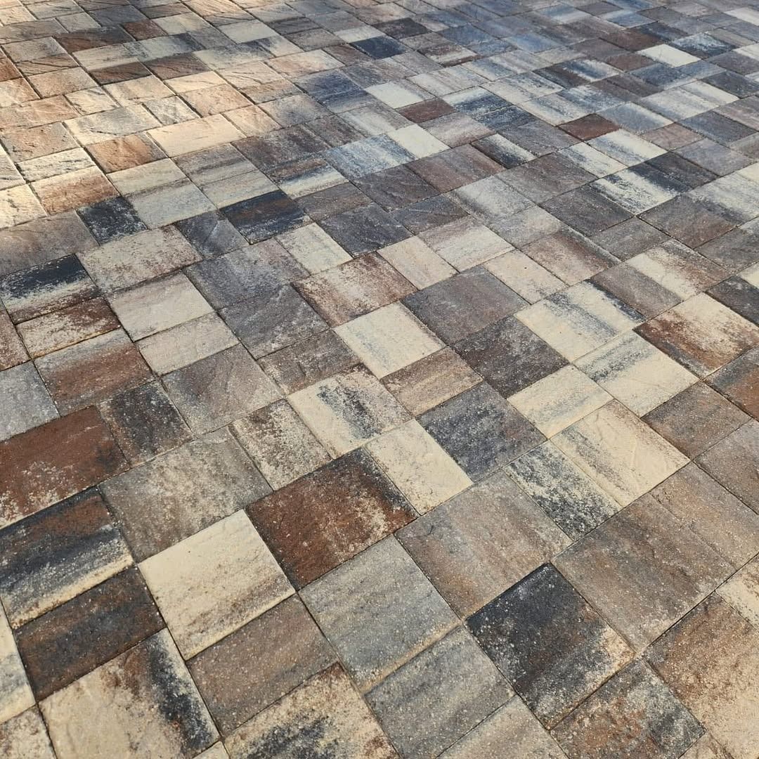 A close up of a brick floor with a geometric pattern.
