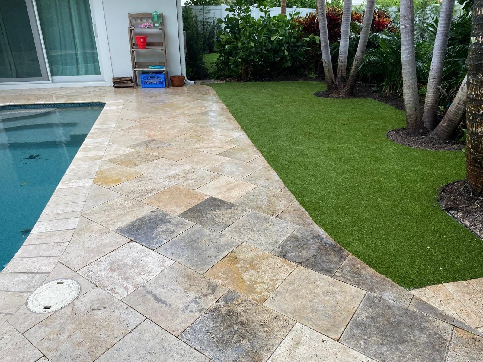 A patio with a swimming pool in the background