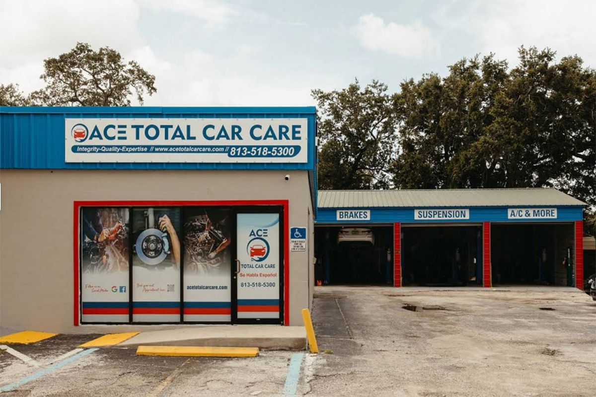 Exterior of Ace Total Car Care building; blue and red signage, entrance.