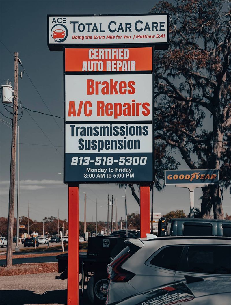 Sign for Total Car Care auto repair, listing services: brakes, AC, transmissions, and suspension