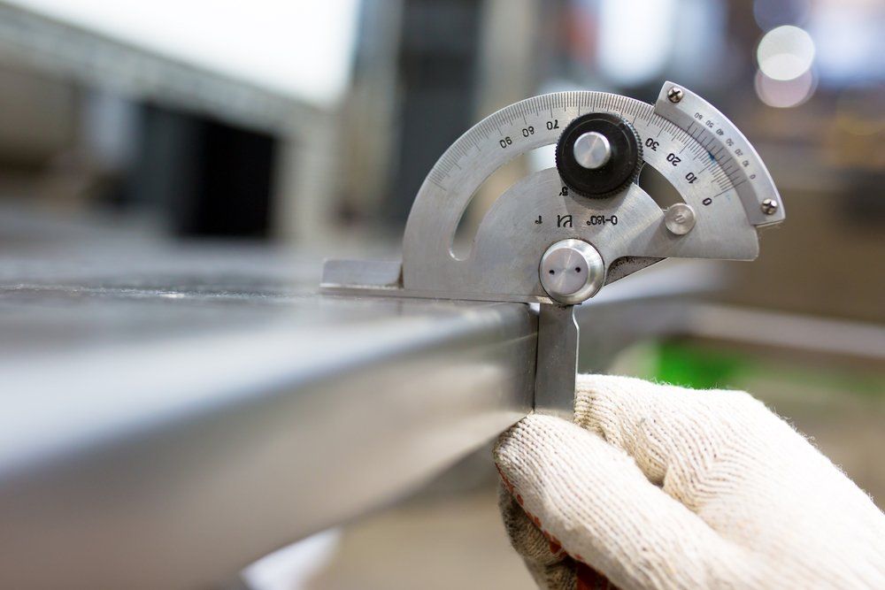 A Person Is Measuring a Piece of Metal with A Protractor — North Coast Steel in Wauchope, NSW