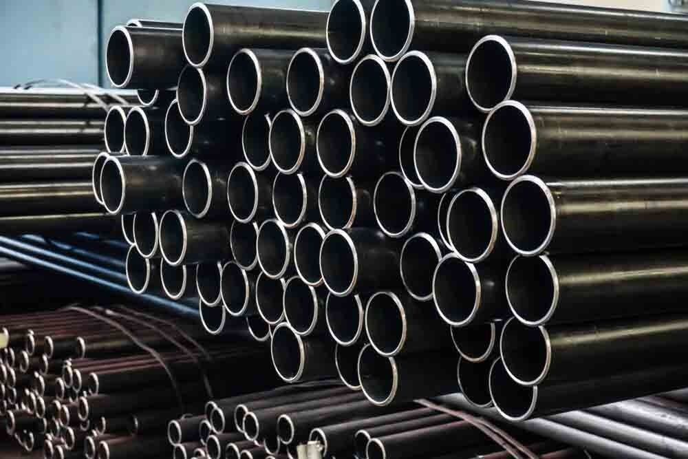 A Bunch of Metal Pipes Are Stacked on Top of Each Other — North Coast Steel in South Kempsey, NSW