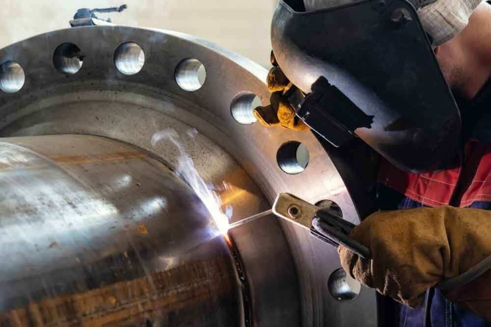 A Man Is Welding a Large Piece of Metal — North Coast Steel in South Kempsey, NSW