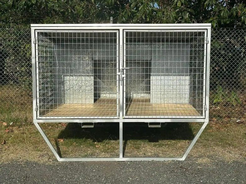A Cage with Two Doors Is Sitting in The Grass Next to A Chain Link Fence — North Coast Steel in South Kempsey, NSW
