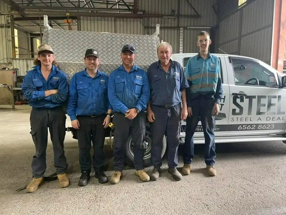 A Group of Men Are Posing for A Picture in Front of A Truck — North Coast Steel in South Kempsey, NSW