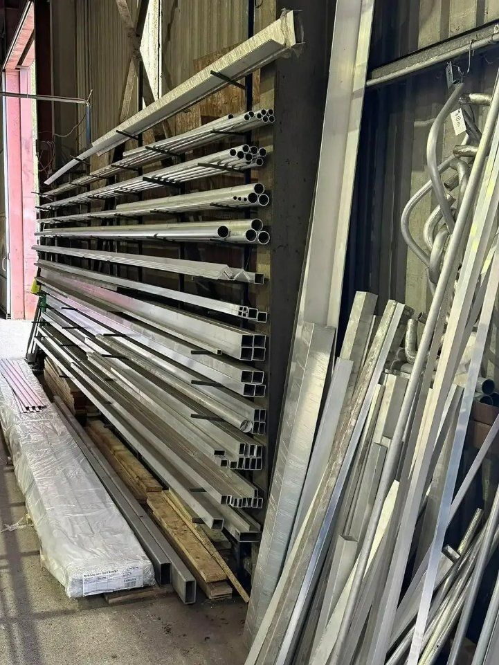 A Bunch of Metal Pipes Are Stacked on Top of Each Other in A Warehouse — North Coast Steel in South Kempsey, NSW