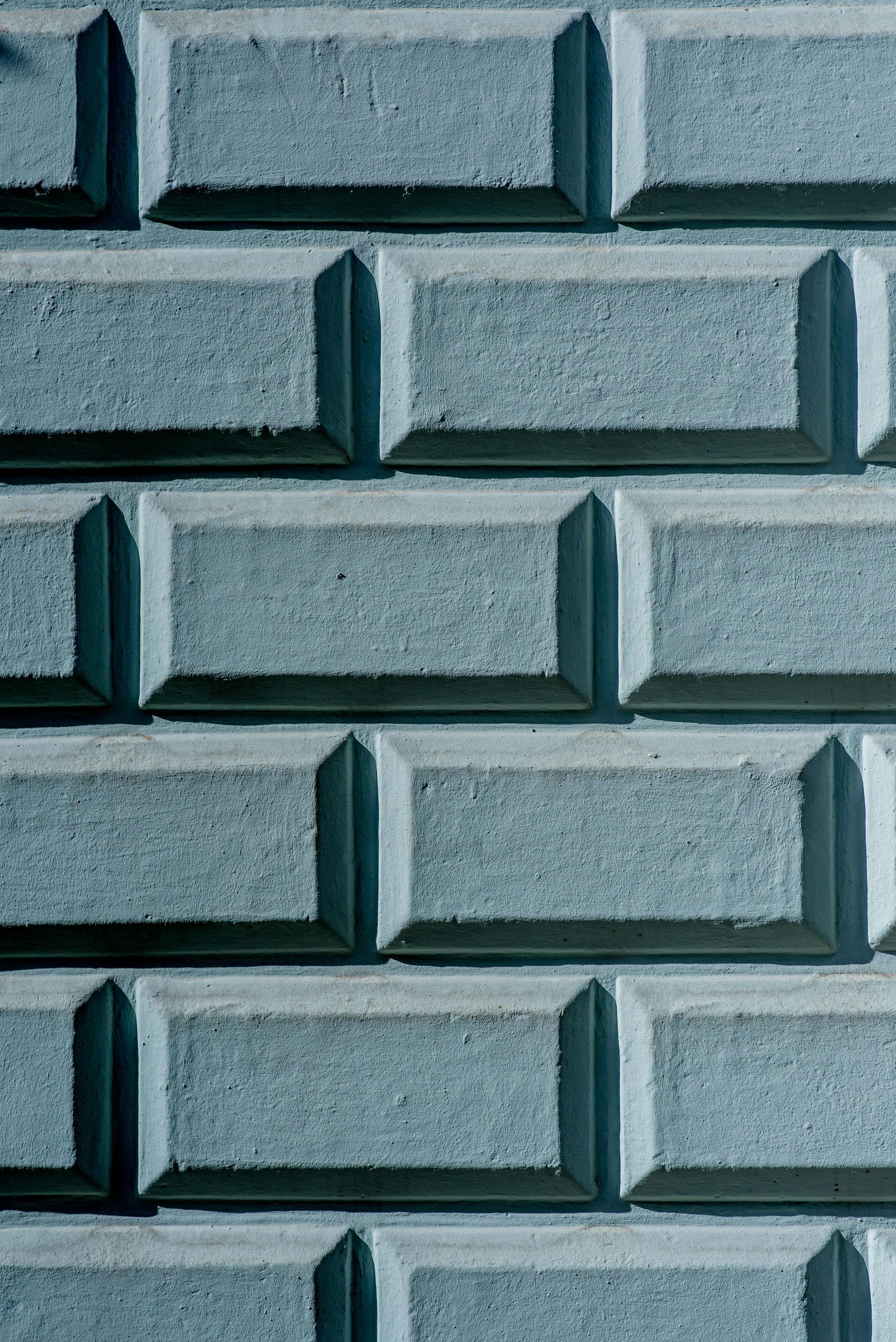 Gray brick wall with shadowed edges.