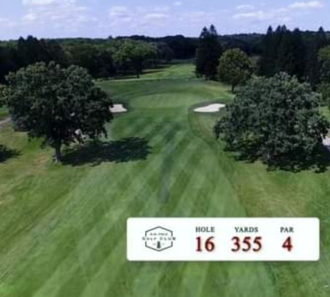 An aerial view of a golf course with a sign that says hole 16 355 4