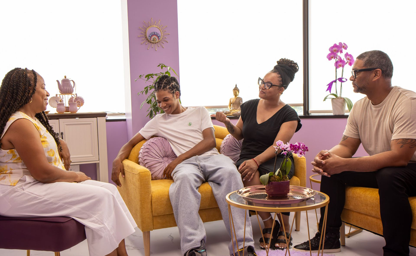 Couples seated with counselor in warm office setting