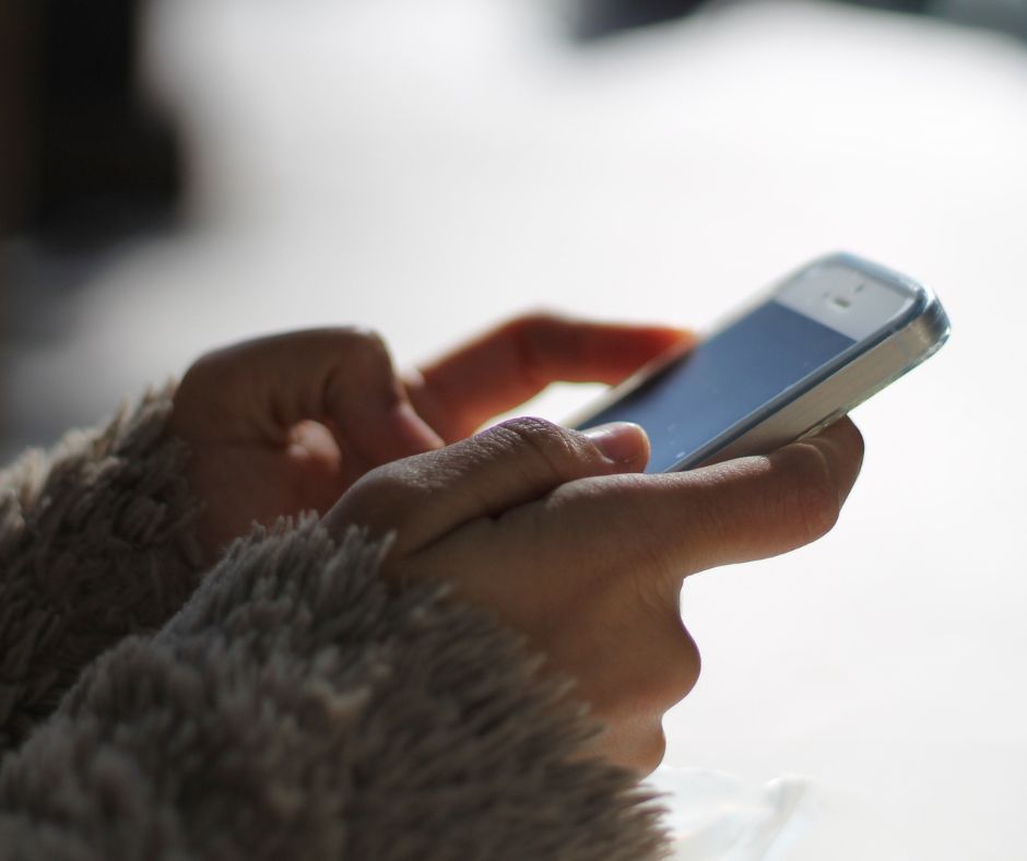 A person is holding a cell phone in their hand