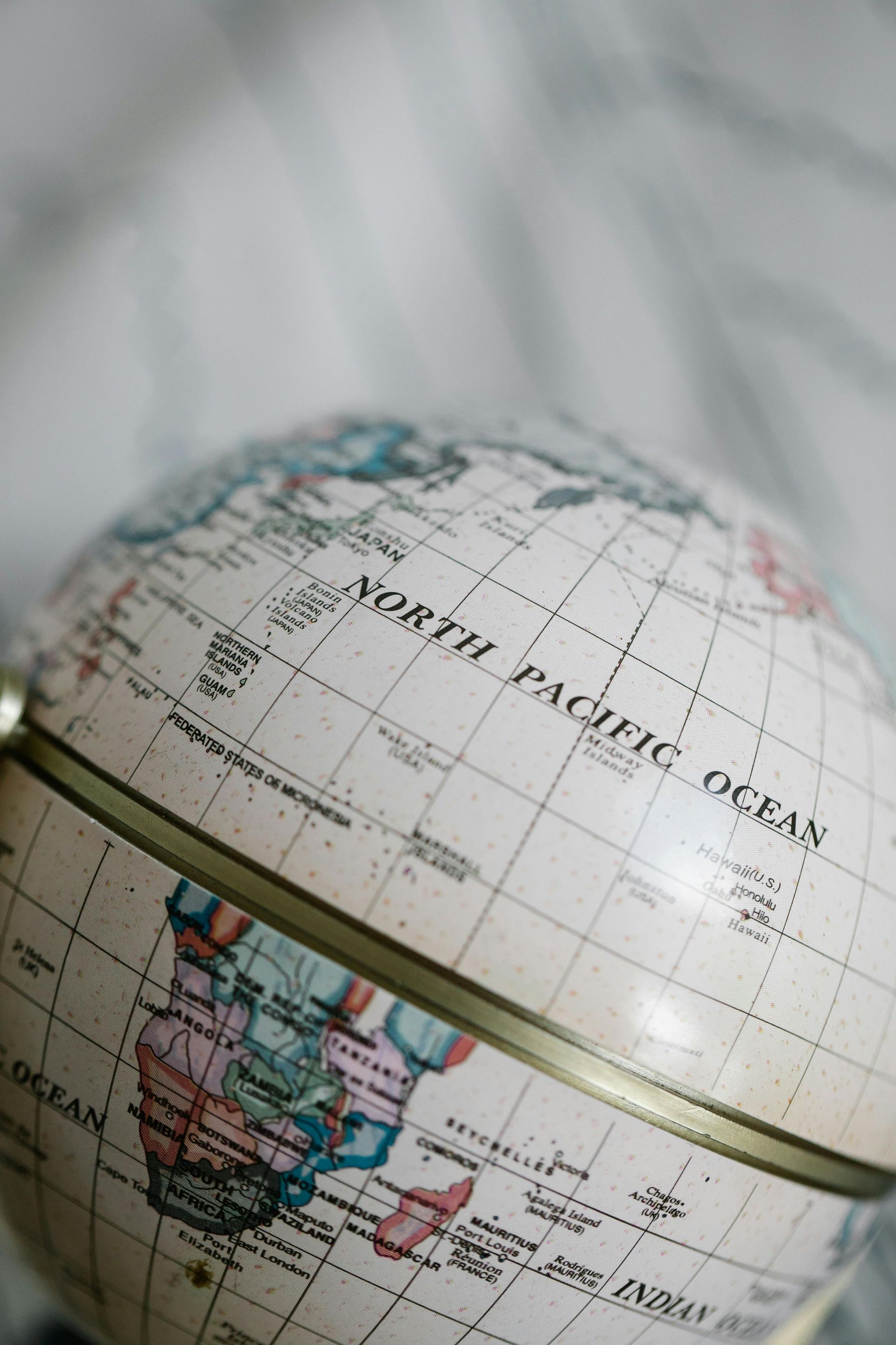 Globe, cream-colored with visible continents and 