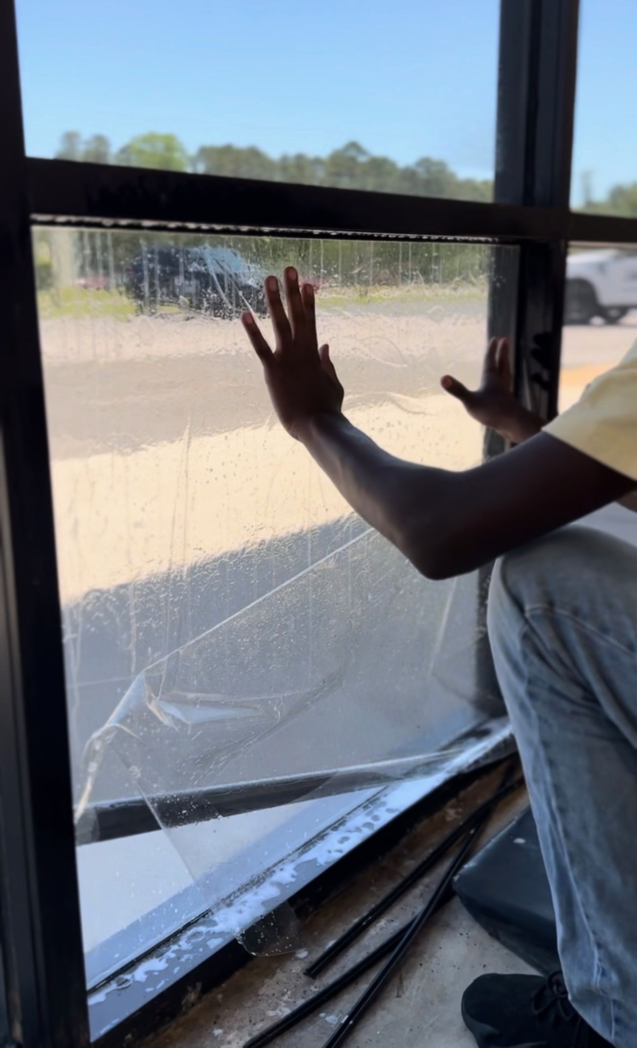 a person is cleaning a window with their hands