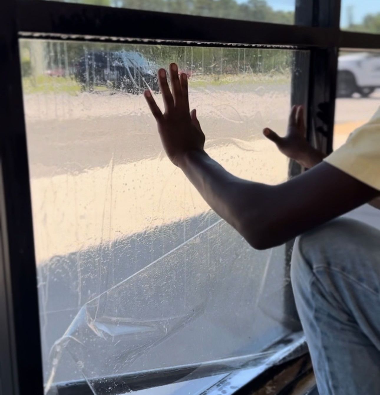 a person is touching a window with their hand