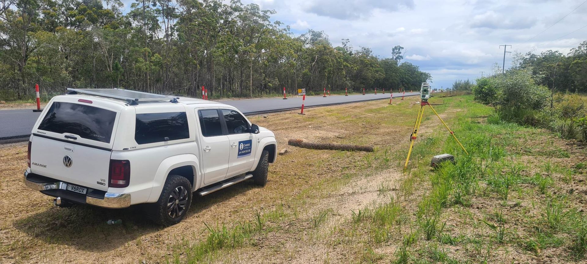 A White Truck is Parked on the Side of the Road — Coastal Surveying Group Pty Ltd in Baringa, QLD