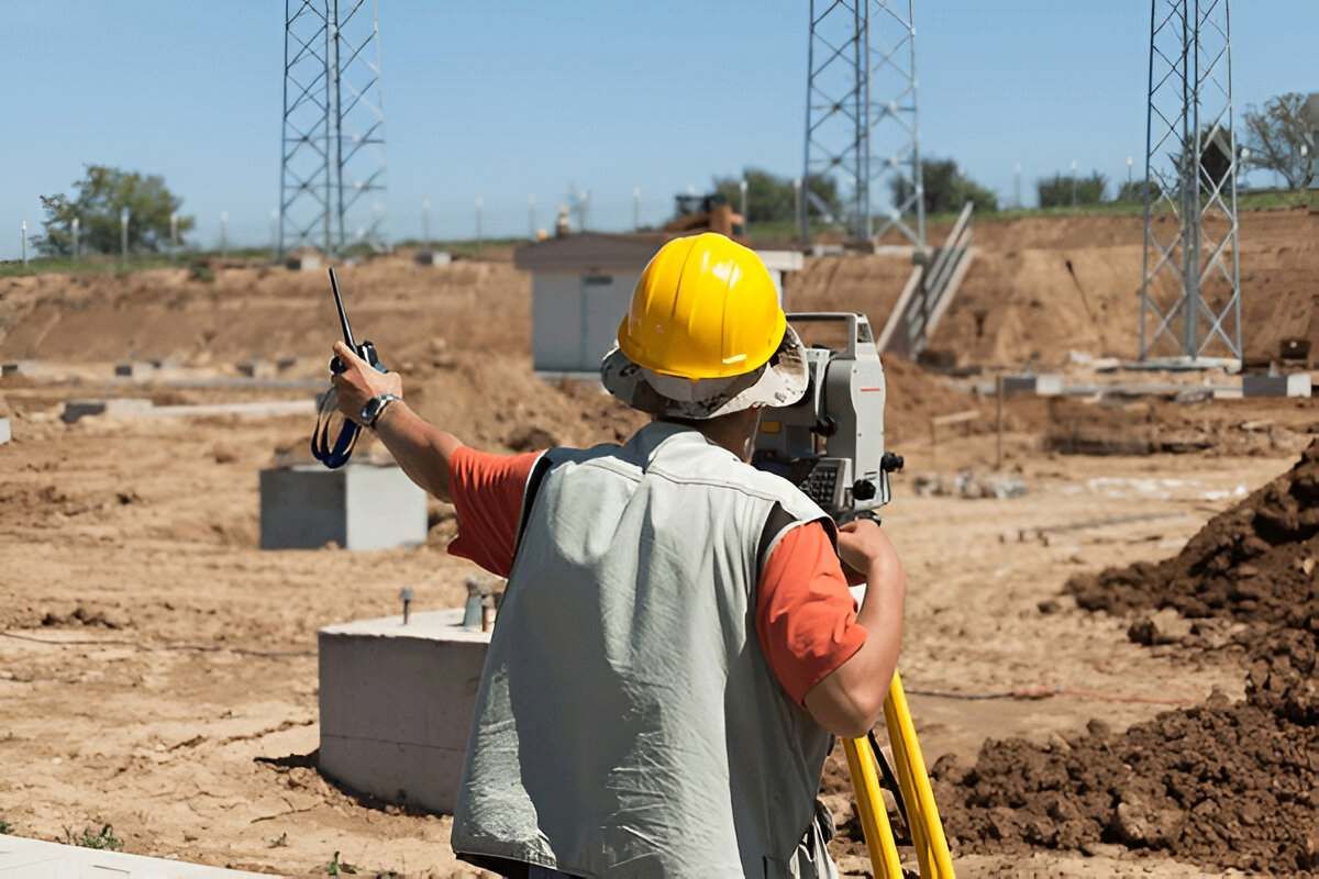 A Construction Worker is Using a Total Station — Coastal Surveying Group Pty Ltd in Baringa, QLD