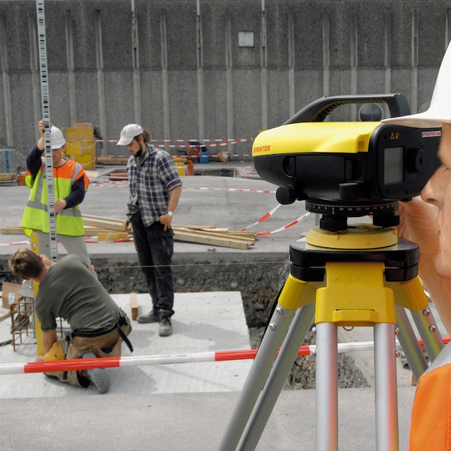 A Man is Looking at a Yellow and Black Device — Coastal Surveying Group Pty Ltd in Baringa, QLD