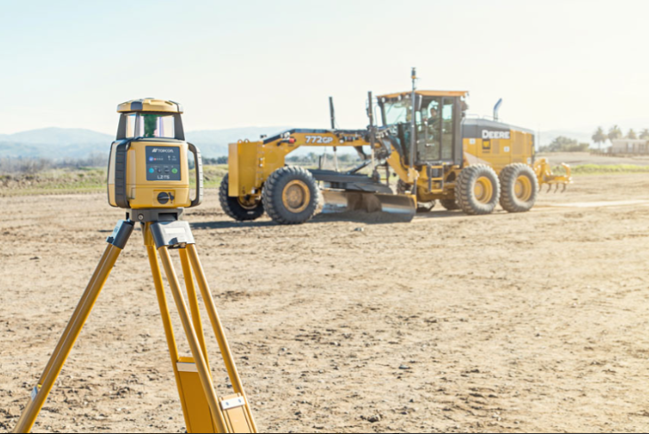 A Laser Level is Sitting in Front of a Bulldozer — Coastal Surveying Group Pty Ltd in Baringa, QLD