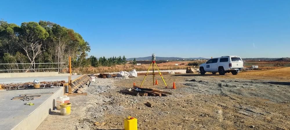A White Truck is Parked in the Middle of a Dirt Field — Coastal Surveying Group Pty Ltd in Baringa, QLD