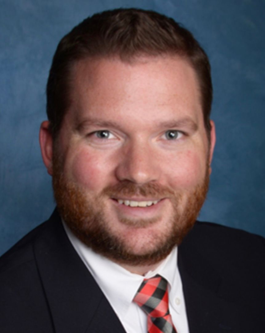 A silhouette of a man standing in a dark hallway