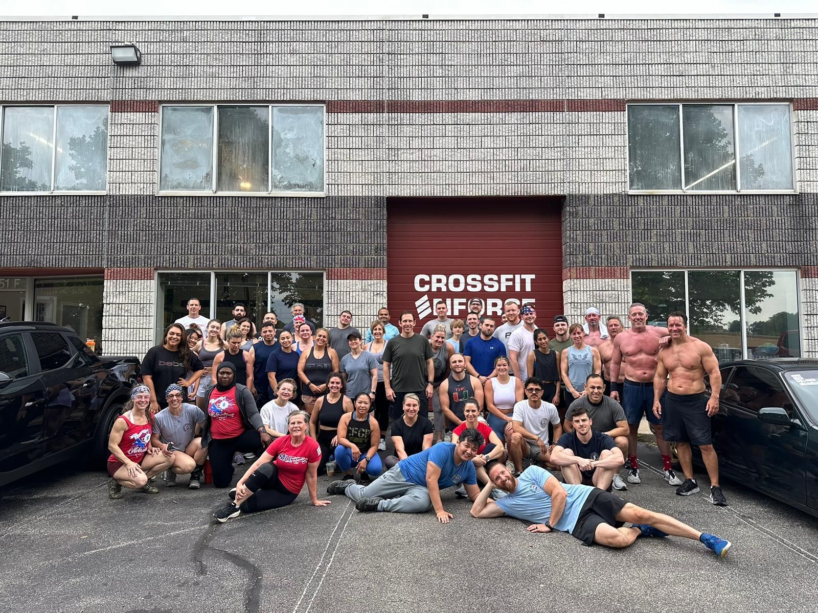 A group of people are posing for a picture in front of a building.