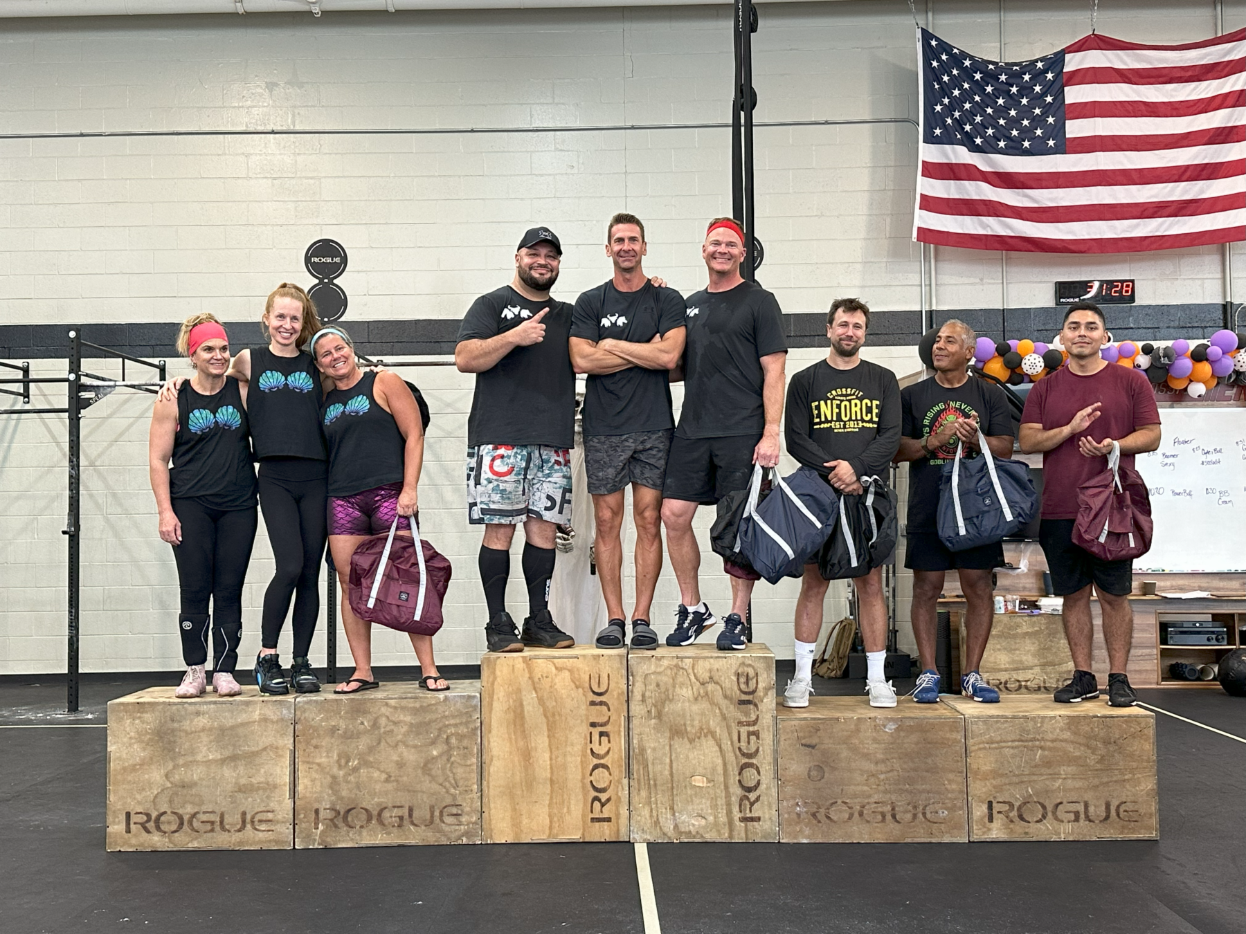A group of people standing on top of wooden boxes in a gym.