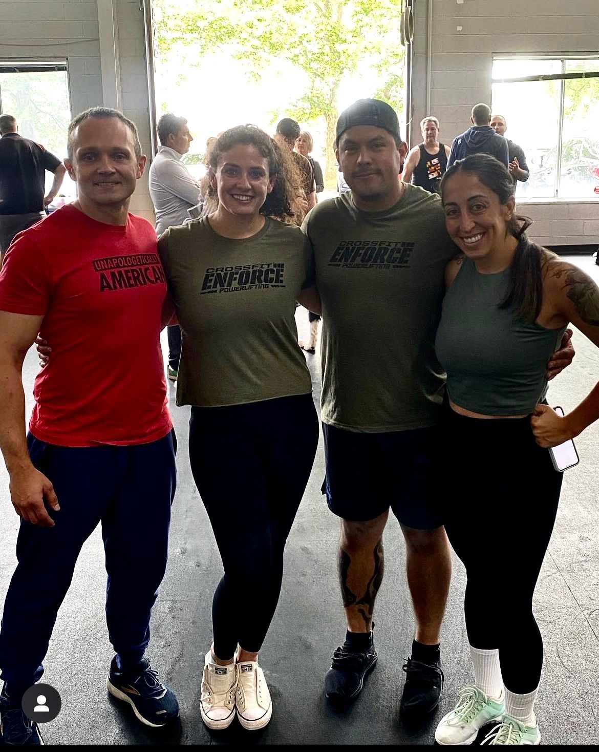 A group of people are posing for a picture in a gym.