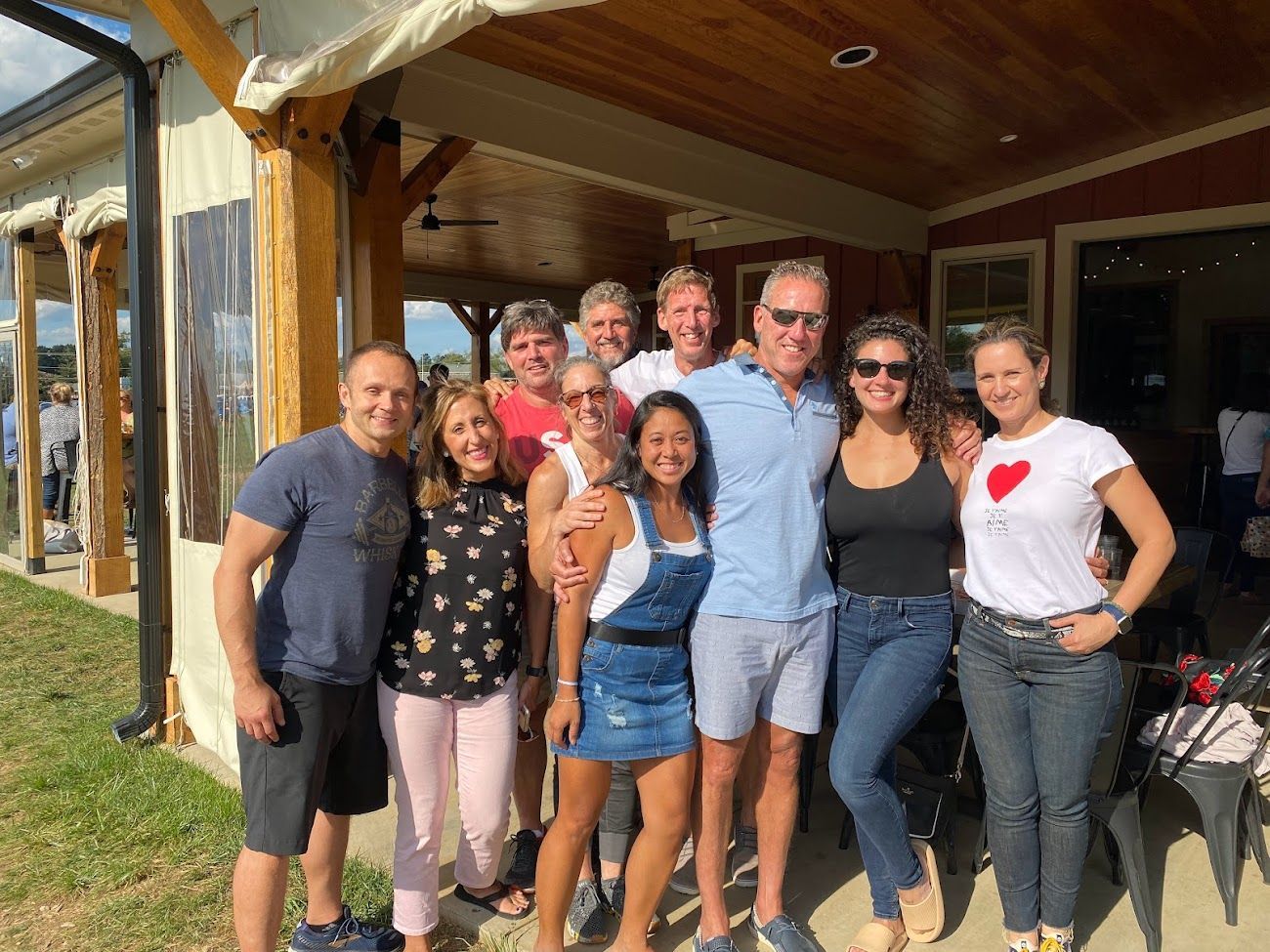 A group of people are posing for a picture in front of a building.