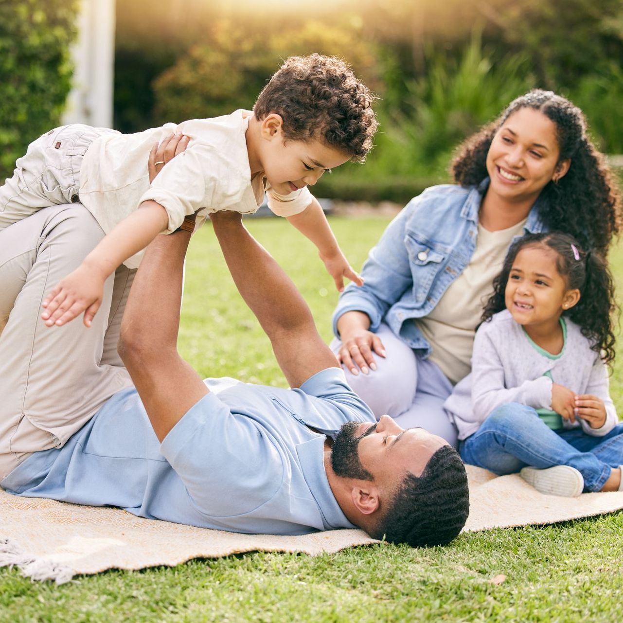 Mother and child laughing on grass outside